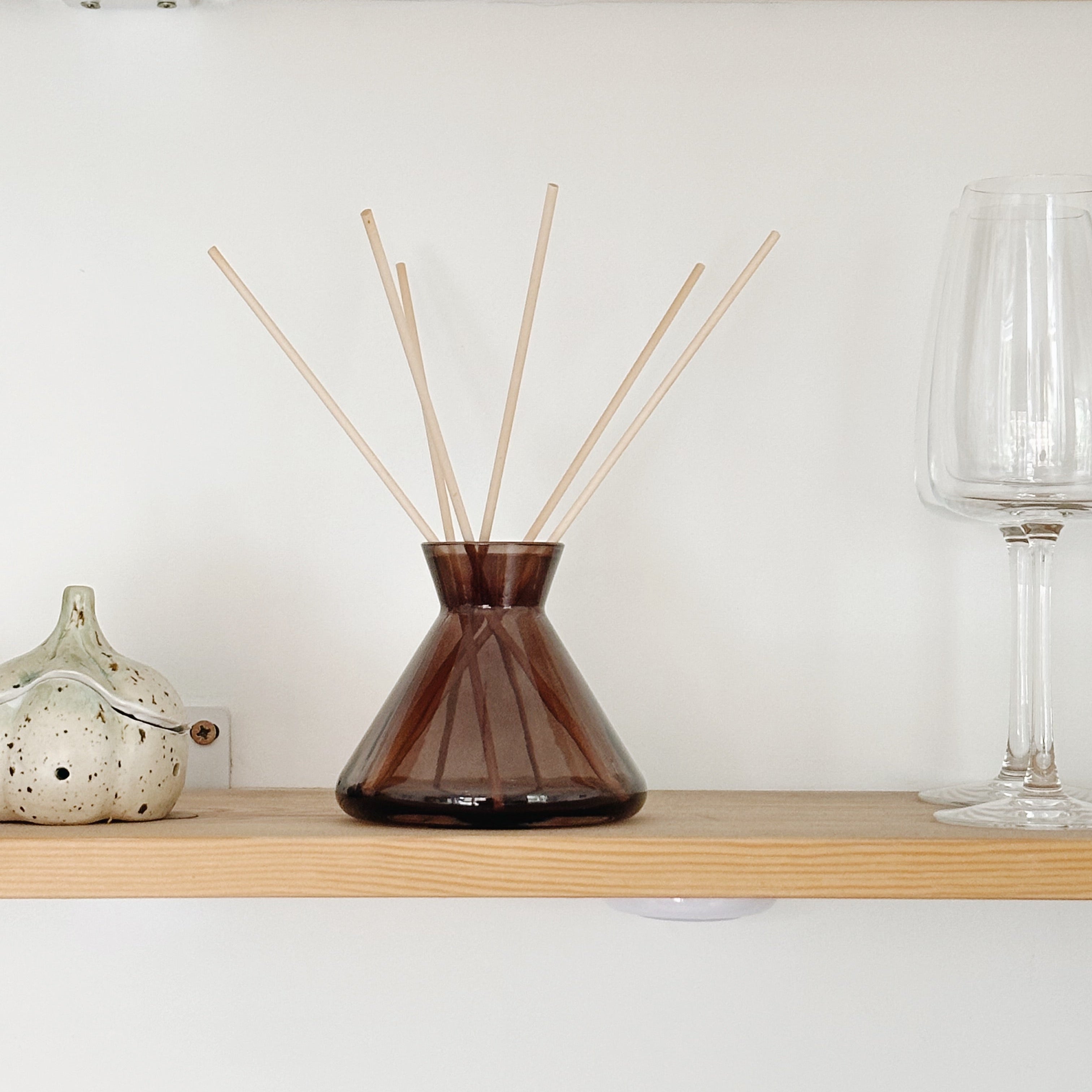 Contemporary glass diffuser bottle décor on shelf